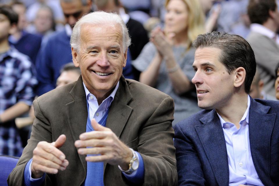 Vice President Joe Biden, left, with his son Hunter, right, at the Duke Georgetown NCAA college basketball game in Washington. Hunter Biden is expressing regret for being discharged from the Navy Reserve amid published reports that he tested positive for cocaine.