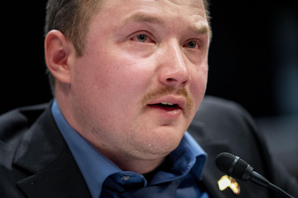 Former Marine Sgt. Tyler Vargas-Andrews, who was gravely injured, losing an arm and a leg in a suicide attack at Hamid Karzai International Airport in Kabul, becomes emotional as he recounts his story during a House Committee on Foreign Affairs hearing on the United States evacuation from Afghanistan on Capitol Hill in Washington, Wednesday, March 8, 2023. (AP Photo/Andrew Harnik)