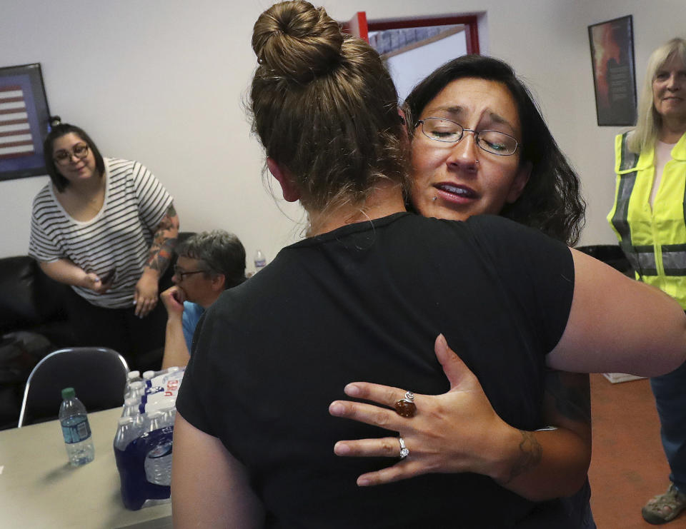 <p>Red Cross volunteer Monica Sierra hugs a friend in Moab, Utah, on Wednesday, June 13, 2018. (Photo: Jeffrey D. Allred/The Deseret News via AP) </p>