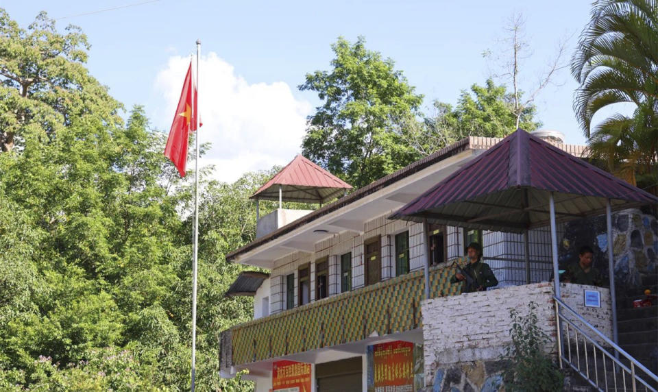 A member of the Myanmar National Democratic Alliance Army takes sentry duty in a sentry post near the flagpole that flew the MNDAA's flag at the border trading gate in Chinshwehaw town, Myanmar, Sunday Oct. 29, 2023. The leader of Myanmar’s army-installed government said the military will carry out counter-attacks against a powerful alliance of ethnic armed groups that has seized towns near the Chinese border in the country’s northeastern and northern regions, state-run media reported Friday Nov. 3, 2023. ("The Kokang" online media via AP)