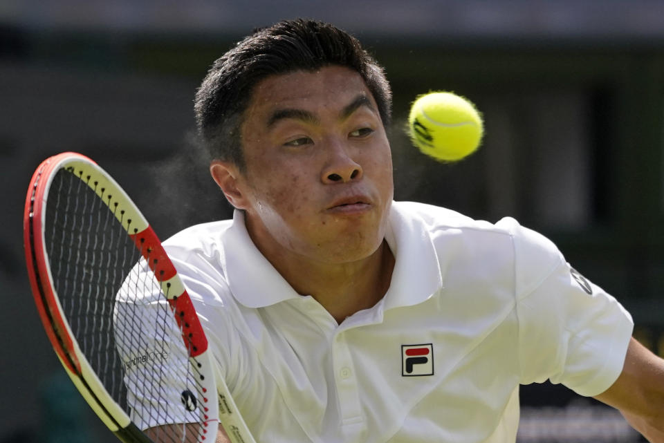 Brandon Nakashima of the US returns to Australia's Nick Kyrgios in a men's singles fourth round match on day eight of the Wimbledon tennis championships in London, Monday, July 4, 2022. (AP Photo/Alberto Pezzali)