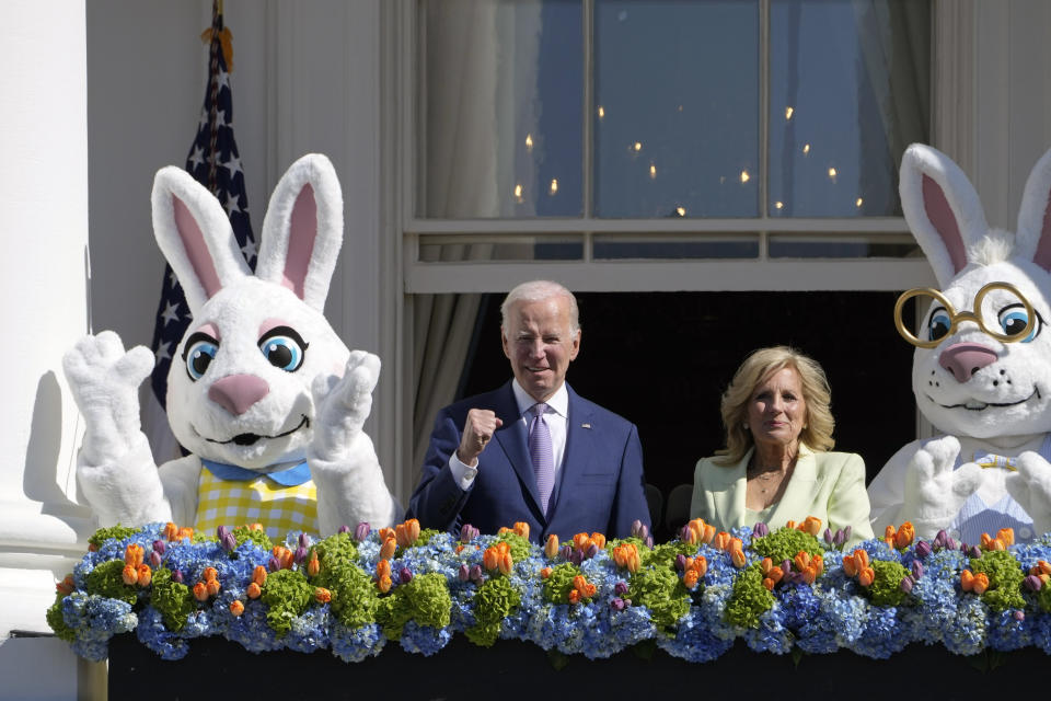 President Joe Biden, accompanied by first lady Jill Biden and Easter Bunnies, stands on the Blue Room Balcony at the White House during the 2023 White House Easter Egg Roll, on Monday, April 10, 2023. (AP Photo/Susan Walsh)