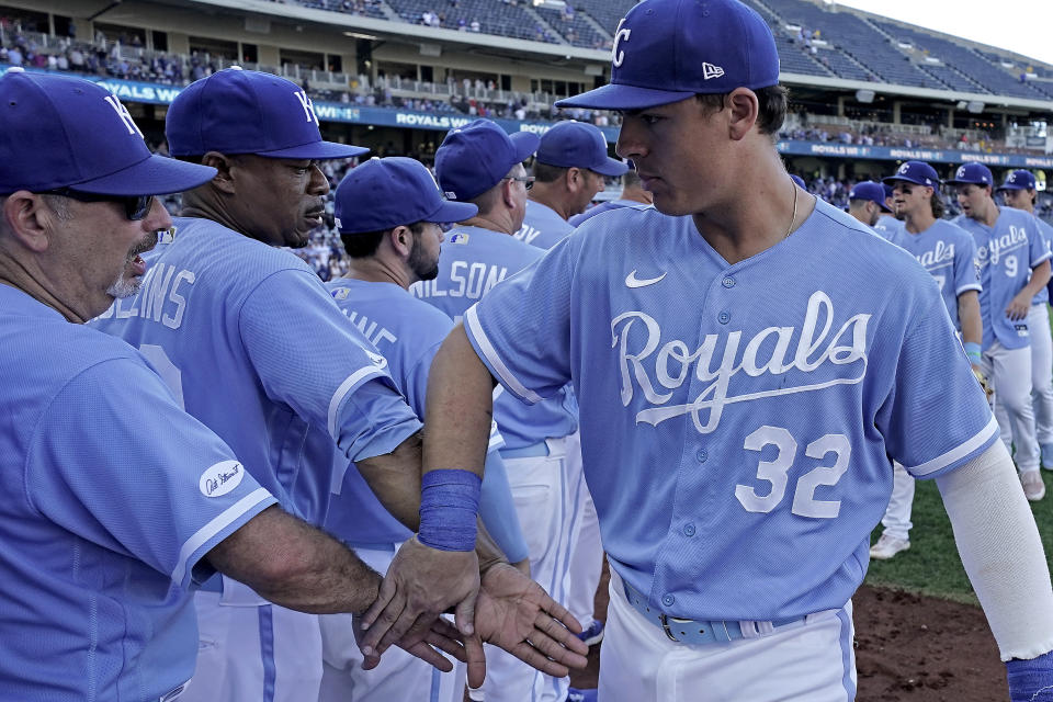 Kansas City Royals' Nick Pratto (32) celebrates with teammates after the first game of a baseball doubleheader against the Chicago White Sox Tuesday, Aug. 9, 2022, in Kansas City, Mo. The Royals won 4-2. (AP Photo/Charlie Riedel)