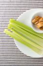 <p>The next time you're craving some crunch, drop the potato chips and grab celery. The veggie is essentially all water and fiber - two things that fill you up quickly - and while one cup of chips can be upward of 160 calories, celery only contains about <a rel="nofollow noopener" href="https://www.calorieking.com/foods/calories-in-fresh-or-dried-vegetables-celery-raw_f-ZmlkPTYzMzAw.html" target="_blank" data-ylk="slk:14 calories per cup,;elm:context_link;itc:0;sec:content-canvas" class="link ">14 calories per cup,</a> chopped. Dip them in a serving of natural peanut butter (it's best if the ingredients list only has peanuts and salt on it) or <a rel="nofollow noopener" href="https://www.womansday.com/food-recipes/food-drinks/a24219950/lentil-hummus-recipe/" target="_blank" data-ylk="slk:hummus;elm:context_link;itc:0;sec:content-canvas" class="link ">hummus</a> for a healthy snack.</p>