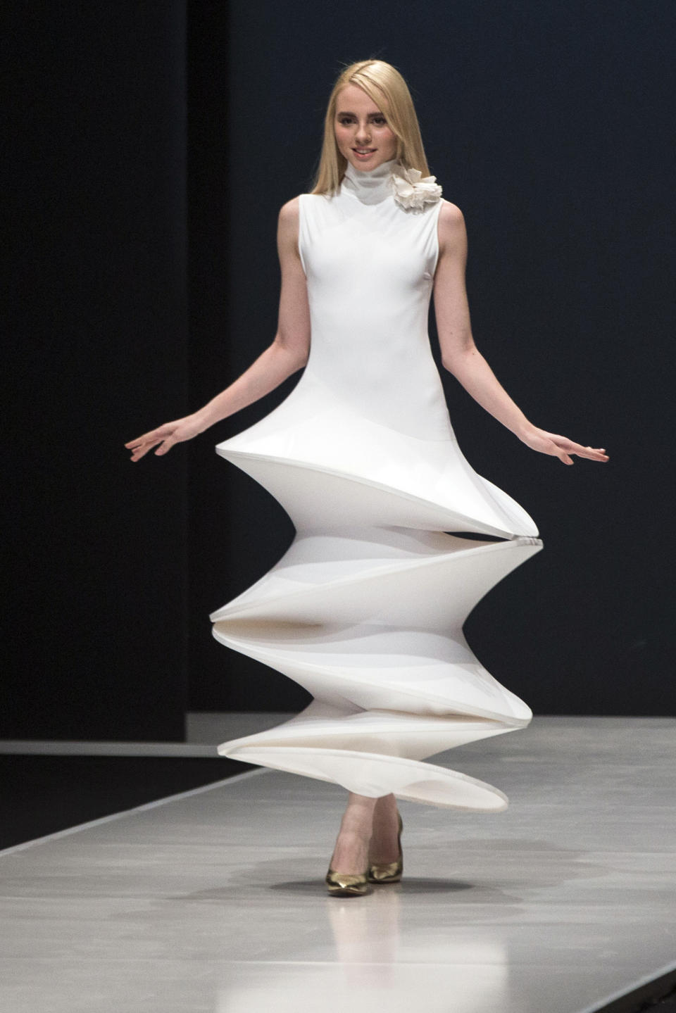FILE - In this March 22, 2016 file photo, a model displays a creation by French fashion designer Pierre Cardin during Moscow Fashion Week, Russia. Pierre Cardin, the French designer whose famous name embossed myriad consumer products after his iconic Space Age styles shot him into the fashion stratosphere in the 1960s, has died, the French Academy of Fine Arts said Tuesday. He was 98. (AP Photo/Pavel Golovkin, File)