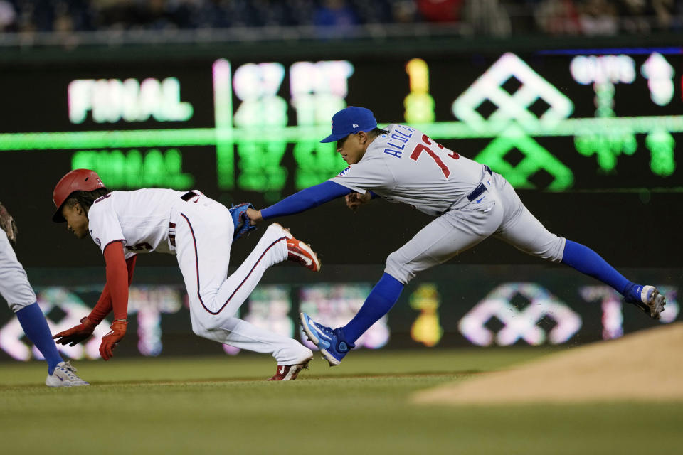 Chicago Cubs' relief pitcher Adbert Alzolay (73) tags out Washington Nationals' CJ Abrams as Abrams is caught stealing second during the seventh inning of a baseball game in Washington, Wednesday, May 3, 2023. (AP Photo/Manuel Balce Ceneta)