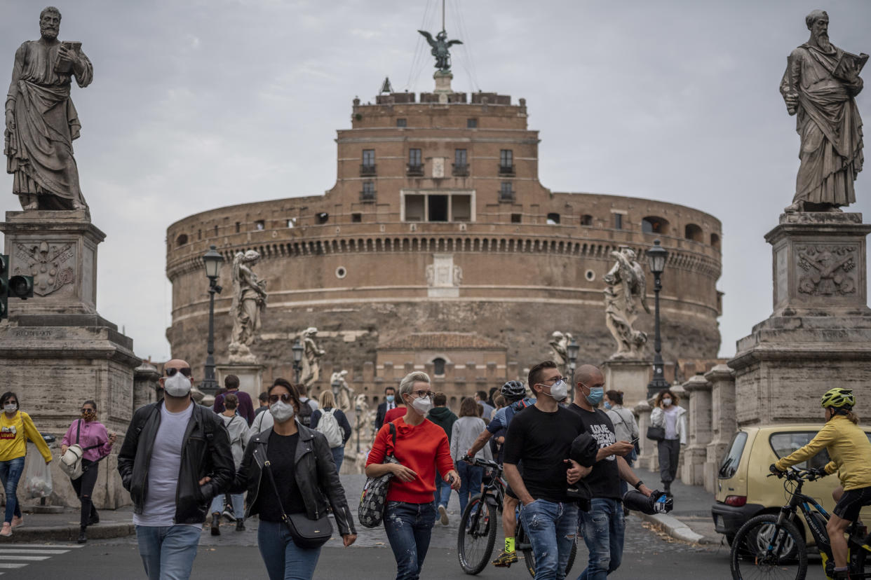 ROME, ITALY - OCTOBER 03: People wearing protective masks walk near Castel SantAngelo amid Covid-19 pandemic, on October 03, 2020 in Rome, Italy. The Lazio region President Nicola Zingaretti set an order obliging people to wear face masks in public including outdoors due to the increase of Covid-19 cases in the Lazio region. (Photo by Antonio Masiello/Getty Images)