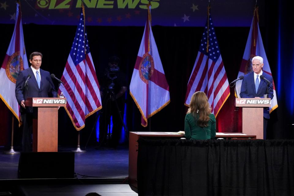 Florida's Republican incumbent Gov. Ron DeSantis and Charlie Crist, a former governor, take the stage at Sunrise Theatre for their only scheduled debate, Monday, Oct. 24, 2022, in Fort Pierce.