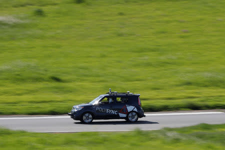 A self-driving car from PolySync drives on the track during a self-racing cars event at Thunderhill Raceway in Willows, California, U.S., April 1, 2017. REUTERS/Stephen Lam