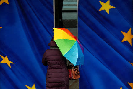 A woman holds an umbrella as she enters the European Commission headquarters in Brussels, Belgium, January 22, 2019. REUTERS/Francois Lenoir