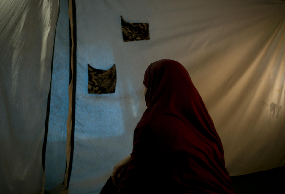 In this Wednesday, March 27, 2019, photo, Samira, a Belgian national, poses for a portrait at Camp Roj, in north Syria. She said she came to believe Islamic State propaganda that Europe would never accept Muslims and only in the caliphate could one be a proper member of the faith. “It was very stupid, I know,” she said. (AP Photo/Maya Alleruzzo)