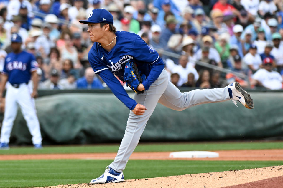 SURPRISE, ARIZONA - FEBRUARY 28, 2024: Yoshinobu Yamamoto #18 of the Los Angeles Dodgers throws a pitch during the second inning of a spring training game against the Texas Rangers at Surprise Stadium on February 28, 2024 in Surprise, Arizona. (Photo by David Durochik/Diamond Images via Getty Images)