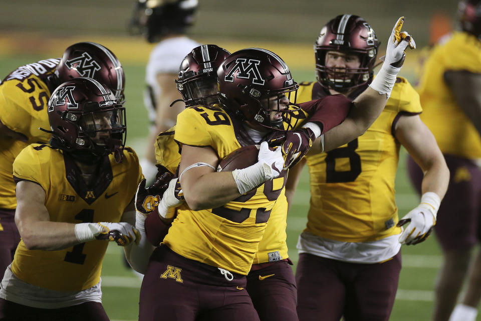Minnesota linebacker Josh Aune (29) holds the ball after he intercepted a Purdue pass during the second half of an NCAA college football game Friday, Nov. 20, 2020, in Minneapolis. Minnesota won 34-31. (AP Photo/Stacy Bengs)