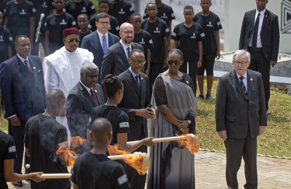 From left to right, Chairperson of the African Union Commission Moussa Faki Mahamat, Rwanda's President Paul Kagame, Rwanda's First Lady Jeannette Kagame, and President of the European Commission Jean-Claude Juncker, light the flame of remembrance at the Kigali Genocide Memorial in Kigali, Rwanda Sunday, April 7, 2019. Rwanda is commemorating the 25th anniversary of when the country descended into an orgy of violence in which some 800,000 Tutsis and moderate Hutus were massacred by the majority Hutu population over a 100-day period in what was the worst genocide in recent history. (AP Photo/Ben Curtis)