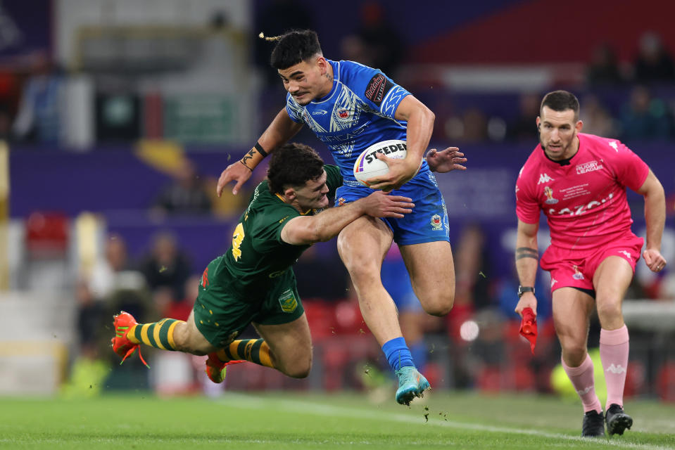 MANCHESTER, ENGLAND - NOVEMBER 19: Taylan May of Samoa is tackled by Nathan Cleary of Australia during the Rugby League World Cup Final match between Australia and Samoa at Old Trafford on November 19, 2022 in Manchester, England. (Photo by George Wood/Getty Images)