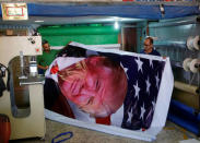 Palestinians print a poster depicting U.S. President Donald Trump in preparations for his planned visit, in the West Bank town of Bethlehem May 21, 2017. REUTERS/Mussa Qawasma