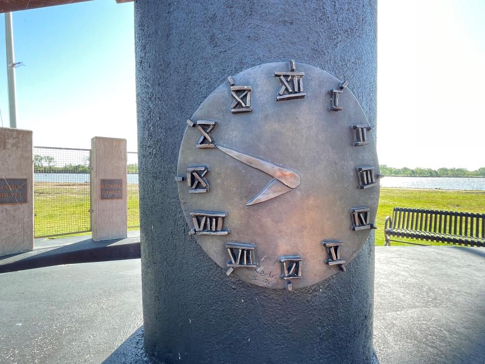 A clock on the Webbers Falls Memorial Park monument shows the time of the morning a barge struck the bridge nearby May 26, 2002.