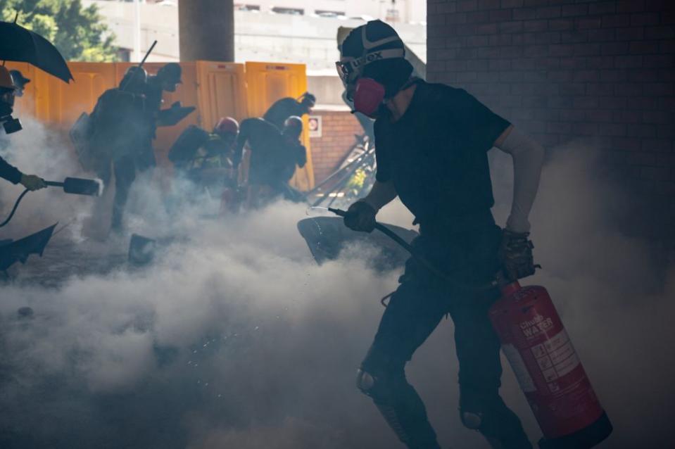 A protestor uses a fire extinguisher amid the chaos in Hong Kong. 