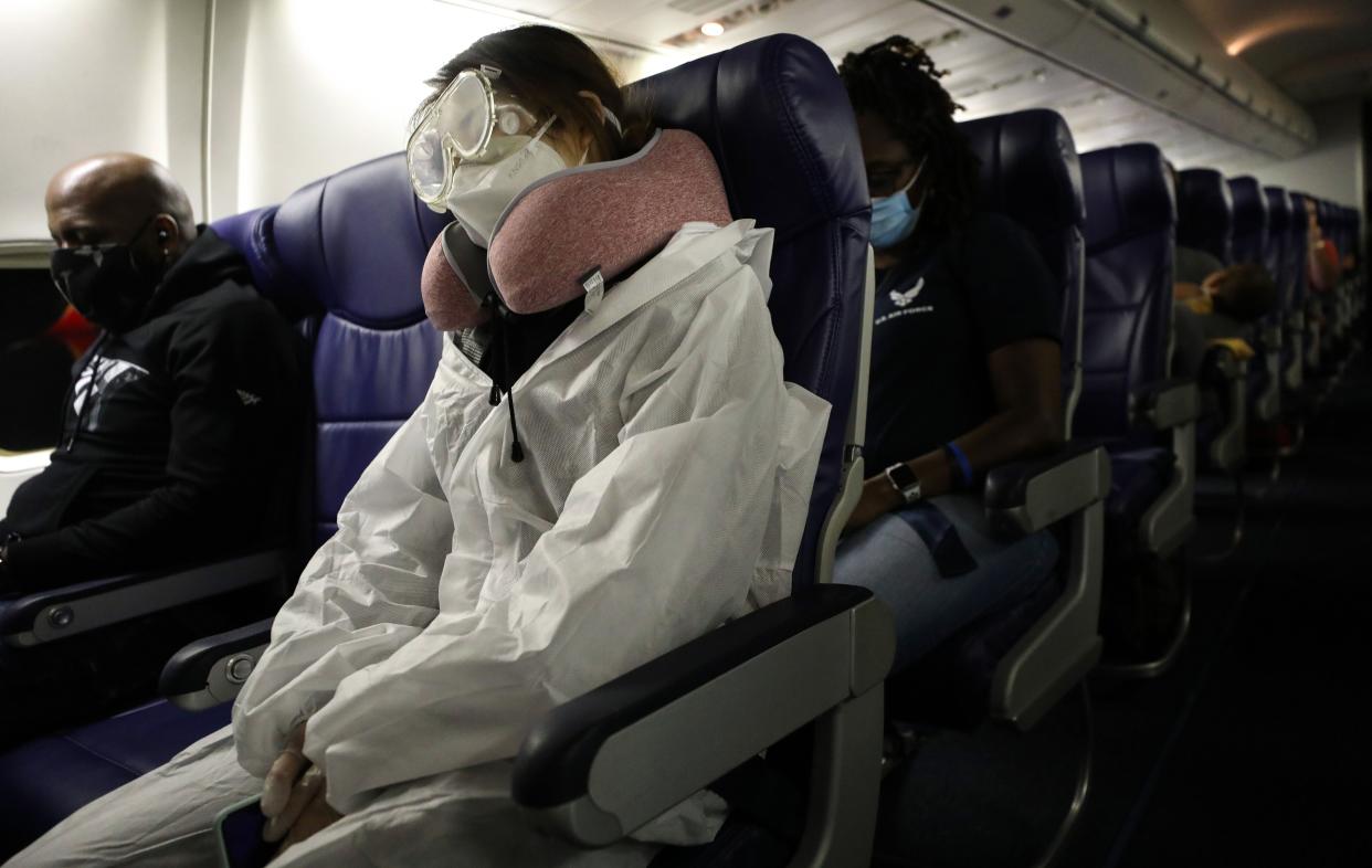 A passenger wears personal protective equipment (PPE) while aboard a Southwest Airlines flight. The airline announced it will unblock the middle seat on flights starting Nov. 30. (Mario Tama/ Getty Images)