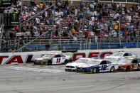 Ryan Blaney (12) narrowly slides by driver Ryan Newman (6) to take the checkered flag in a NASCAR Cup Series auto race at Talladega Superspeedway, Monday, Oct 14, 2019, in Talladega, Ala. (AP Photo/Amanda Newman)