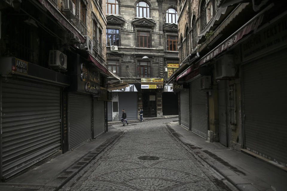 People walk in Eminonu market, an area usually packed with shop goers, but currently nearly deserted due to the strict lockdown to help curb the spread of the coronavirus, in Istanbul, Saturday, May 8, 2021. The "full lockdown," which began in late April and will last until May 17 came amid a huge surge in infections. (AP Photo/Emrah Gurel)