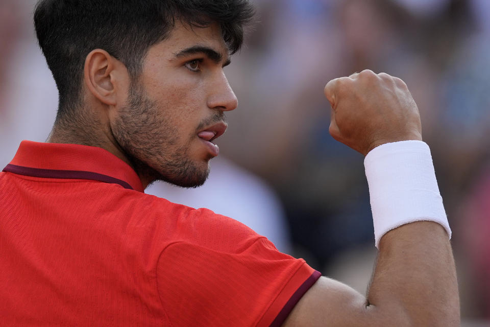 Carlos Alcaraz of Spain reacts after scoring a point against Tallon Griekspoor of the Netherlands during their men's singles second round match, at the 2024 Summer Olympics, Monday, July 29, 2024, at the Roland Garros stadium in Paris, France. (AP Photo/Andy Wong)