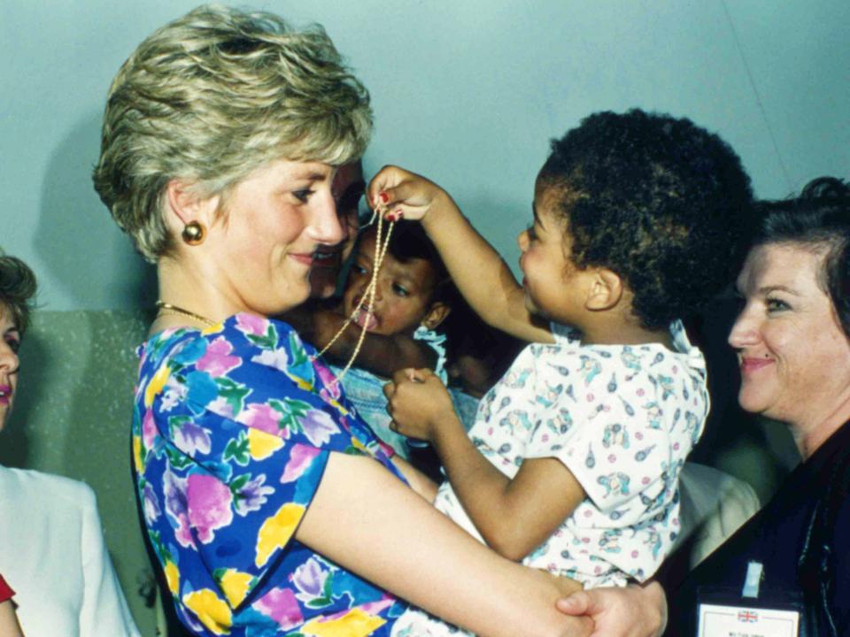 Princess Diana hugs and plays with an HIV positive baby in 1991.