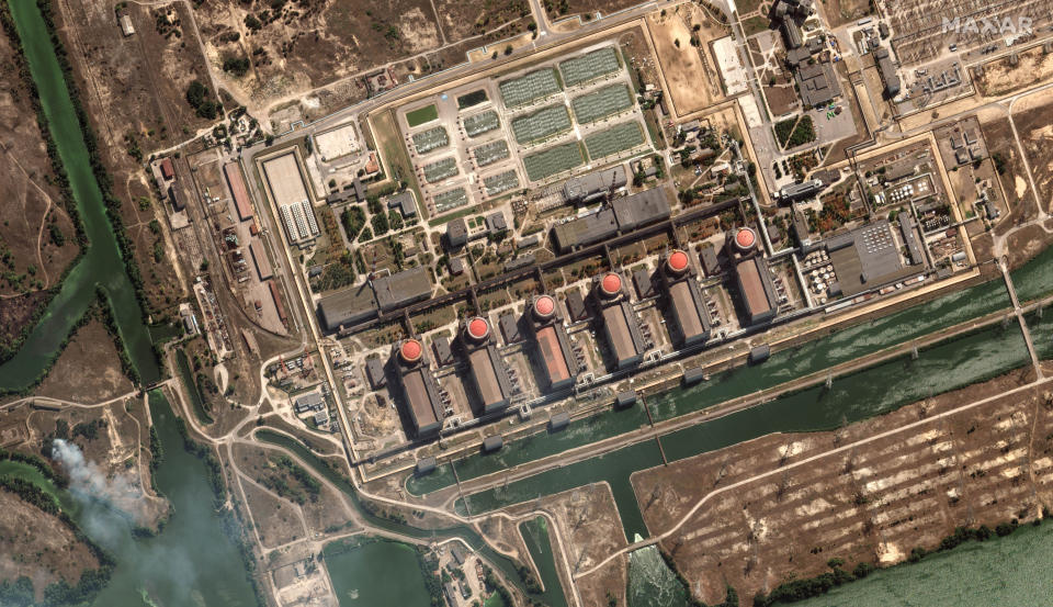 This satellite image provided by Maxar Technologies shows bush fires outside of the main power plant facilities at the Zaporizhzhia nuclear plant in Russian occupied Ukraine, Monday Aug. 29, 2022. A team from the U.N. nuclear watchdog on Monday started its journey to the Zaporizhzhia atomic power plant at the heart of fighting in Ukraine, a long-awaited mission to inspect crucial safety systems that the world hopes will help avoid a catastrophe. (Satellite image ©2022 Maxar Technologies via AP)