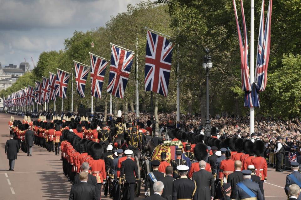 The coffin of Queen Elizabeth II, draped in the Royal Standard, is carried on a horse-drawn gun carriage of the King’s Troop Royal Horse Artillery during the ceremonial procession from Buckingham Palace to Westminster Hall (Vadim Ghirda/PA) (PA Wire)