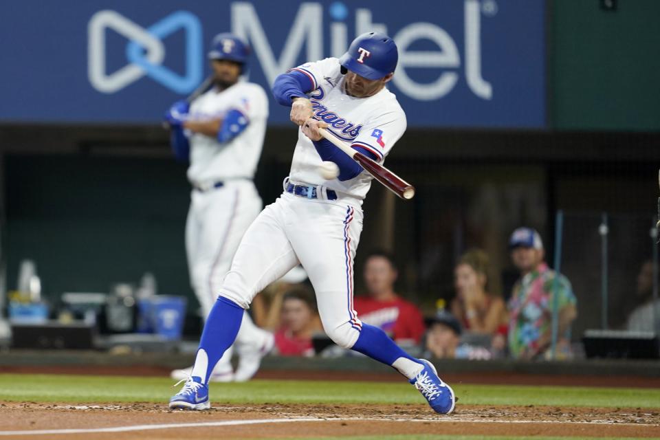 Texas Rangers' Brad Miller connects for a two-run single in the second inning of a baseball game against the Philadelphia Phillies, Wednesday, June 22, 2022, in Arlington, Texas. The hit scored Jonah Heim and Josh Smith. (AP Photo/Tony Gutierrez)