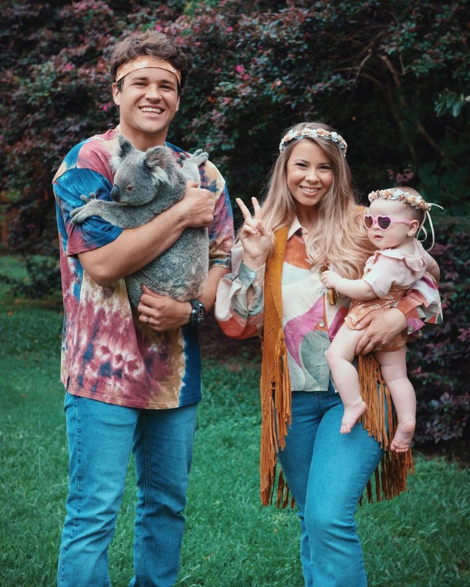 Chandler Powell and Bindi Irwin with their baby Grace dressed as hippies for Halloween in 2021. Photo: Instagram/bindisueirwin.