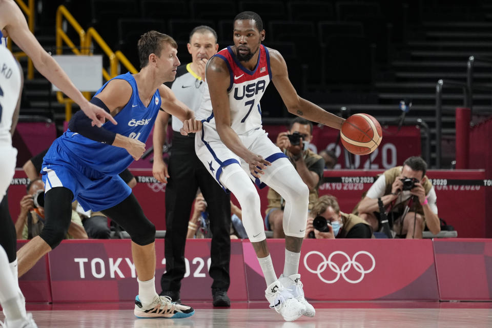 United States's Kevin Durant (7) works the ball against Czech Republic's Jan Vesely (24) during a men's basketball preliminary round game at the 2020 Summer Olympics, Saturday, July 31, 2021, in Saitama, Japan. (AP Photo/Eric Gay)