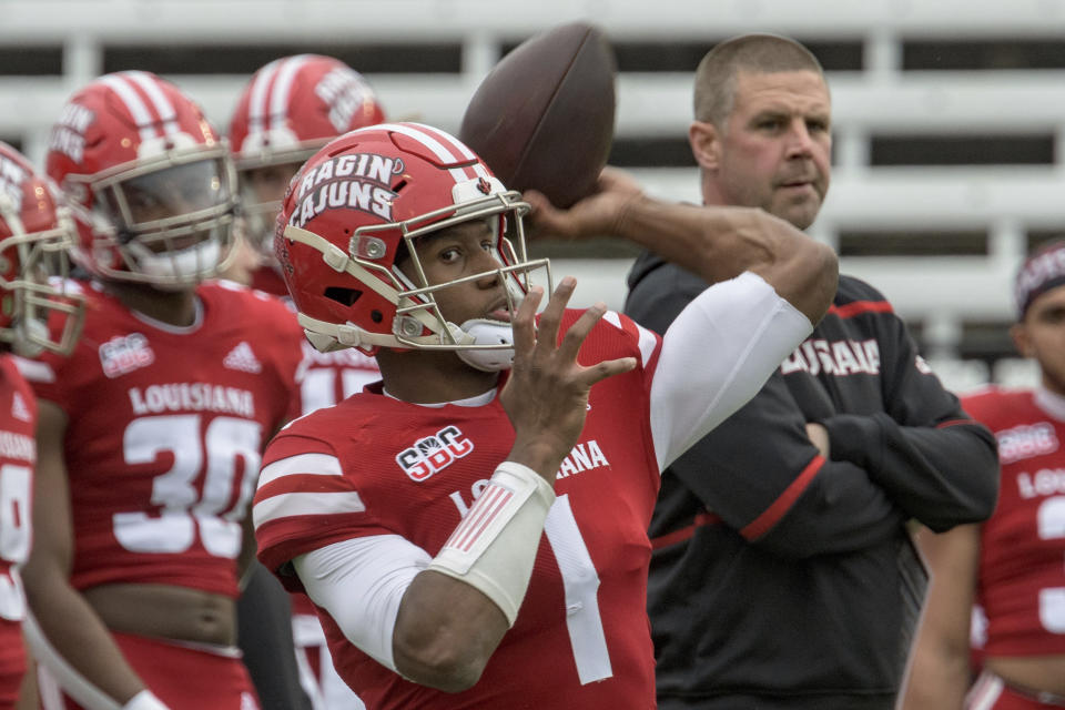 Louisiana-Lafayette head coach Billy Napier, right, watches Louisiana-Lafayette quarterback Levi Lewis (1) warm up before an NCAA college football game against Louisiana-Monroe in Lafayette, La., Saturday, Nov. 27, 2021. (AP Photo/Matthew Hinton)