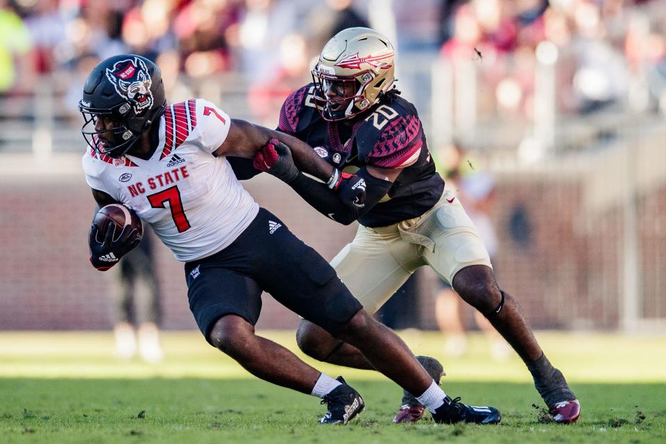 Florida State Seminoles linebacker Kalen DeLoach (20) tackles North Carolina State Wolfpack running back Zonovan Knight (7). The North Carolina State Wolfpack lead the Florida State Seminoles 14-0 at the half Saturday, Nov. 6, 2021.