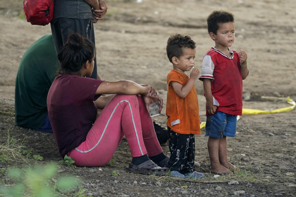 Migrants wait to be processed by the Border Patrol after illegally crossing the Rio Grande river from Mexico into the U.S. at Eagle Pass, Texas, Friday, Aug. 26, 2022. The area has become entangled in a turf war between the Biden administration and Texas Gov. Greg Abbott over how to police the U.S. border with Mexico. (AP Photo/Eric Gay)