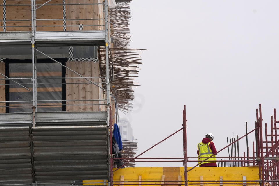 Workers build the Olympic Village at the Porta Romana former railway yard, in Milan, Italy, Tuesday, Feb. 6, 2024. The 2026 Milan-Cortina Olympics start exactly two years from Tuesday and it still seems like there are more questions than answers for a complicated games that will be staged across a large swath of northern Italy spread between five different venue clusters. (AP Photo/Antonio Calanni)