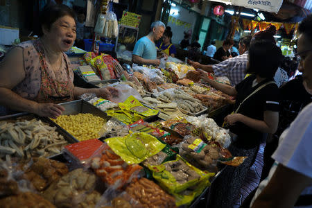 People shop for vegetarian food at a market in Chinatown Bangkok, Thailand, October 19, 2017. Picture taken October 19, 2017. REUTERS/Athit Perawongmetha