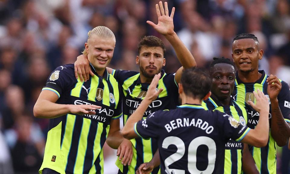 <span>Erling Haaland (left) is congratulated by teammates after doubling Manchester City’s lead.</span><span>Photograph: Hannah McKay/Reuters</span>