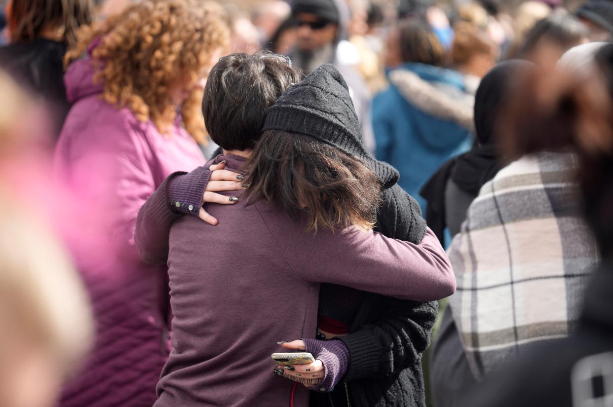 A parent hugs a student as they are reunited after a school shooting at East High School Wednesday, March 22, 2023, in Denver (AP)