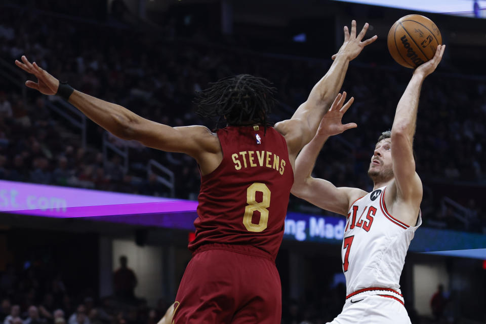 Chicago Bulls guard Goran Dragic (7) shoots against Cleveland Cavaliers forward Lamar Stevens (8) during the first half of an NBA basketball game, Monday, Jan. 2, 2023, in Cleveland. (AP Photo/Ron Schwane)