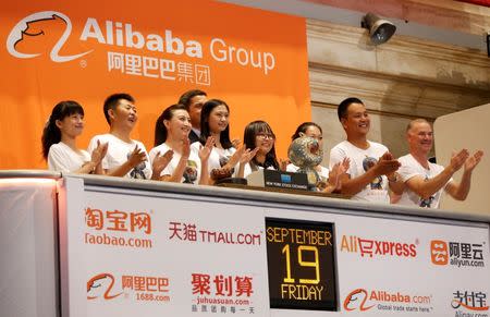 Alibaba employees applaud as the opening bell of the New York Stock Exchange is rung, before the initial public offering (IPO) of Alibaba Group Holding Ltd under the ticker "BABA" in New York September 19, 2014. REUTERS/Lucas Jackson