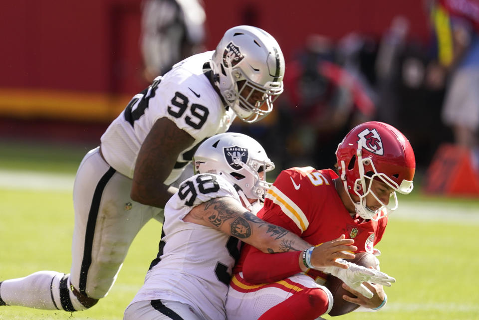 Kansas City Chiefs quarterback Patrick Mahomes (15) is sacked by Las Vegas Raiders defensive end Maxx Crosby (98) and defensive end Arden Key (99) during the second half of an NFL football game, Sunday, Oct. 11, 2020, in Kansas City. (AP Photo/Charlie Riedel)