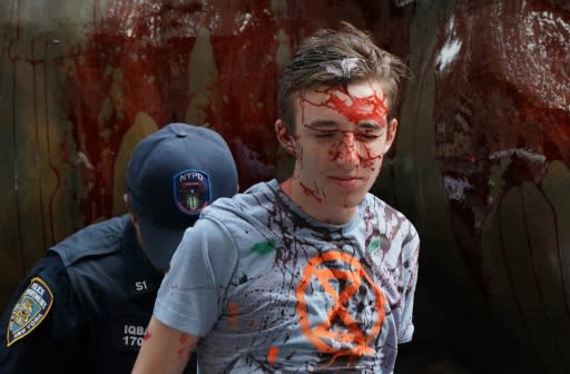 Protestors covered in fake blood are arrested by the NYPD around the Wall Street Bull during an ?Extinction Rebellion? demonstration in New York