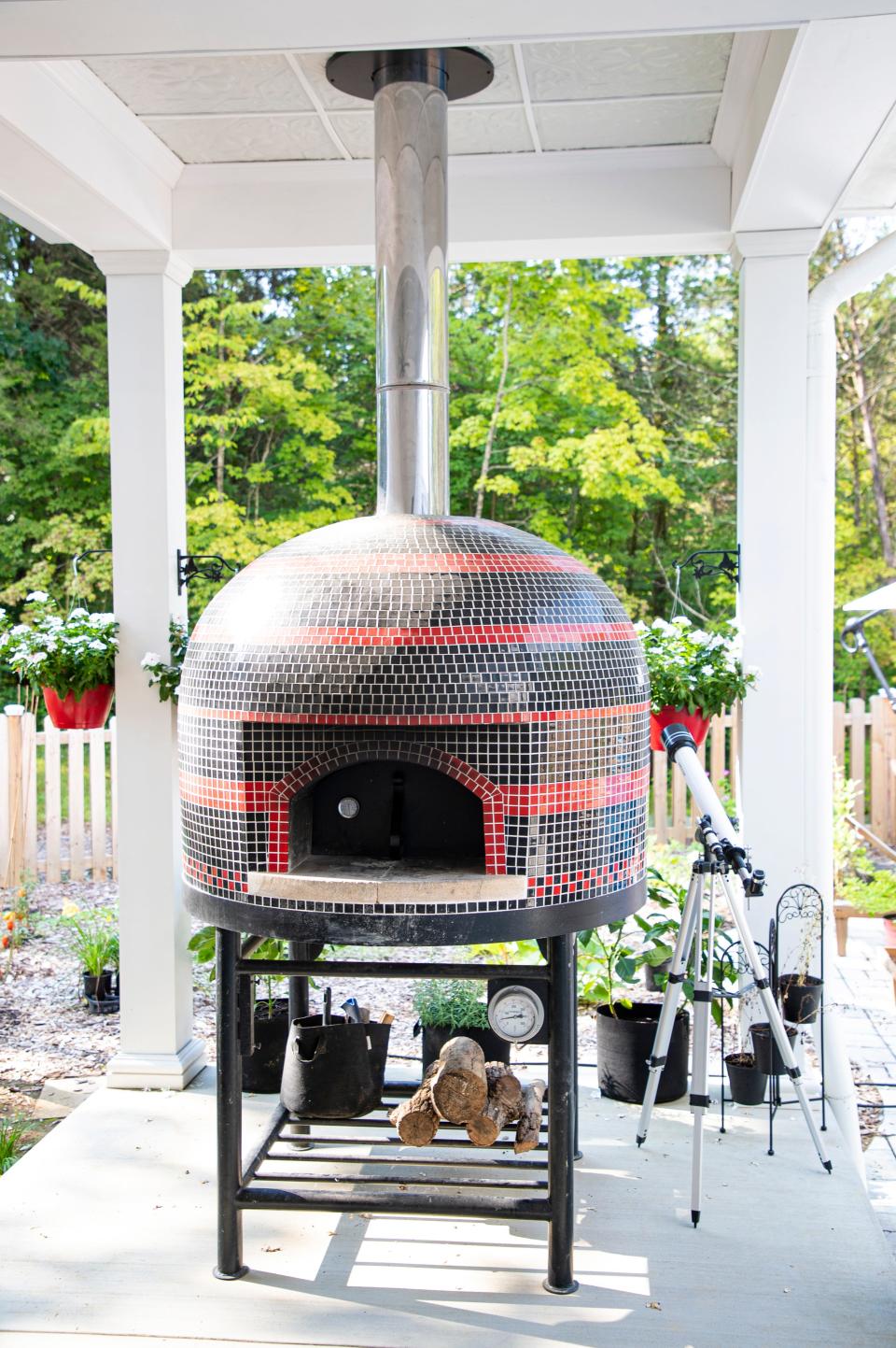 An outdoor pizza oven sits in a covered area off from the pool and garden at the home of the Kaelin's in the Pine Valley Estates subdivision. Aug. 24, 2020