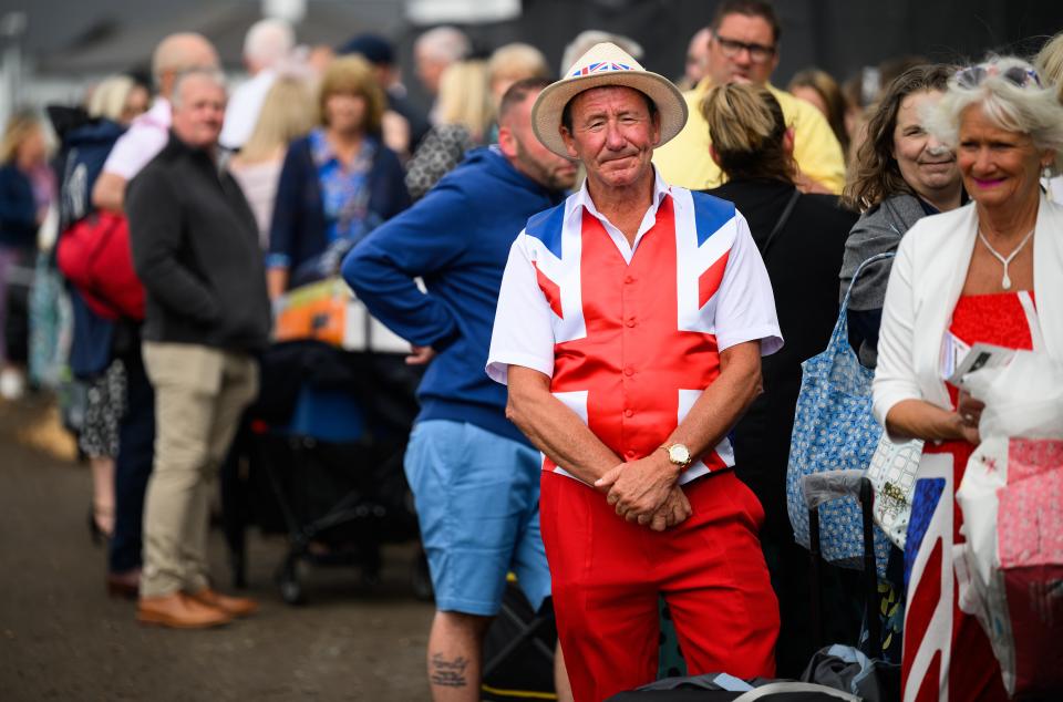 A man wearing Union Flag clothing queues to enter an enclosure, as racegoers prepare for the days events (Getty Images)