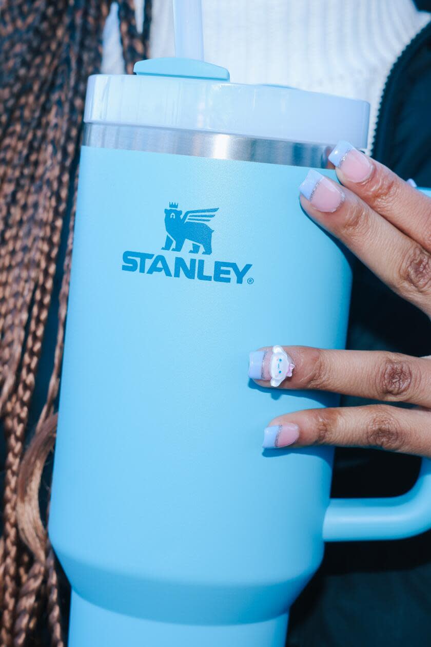 Kimora Johnson holds a Stanley cup water bottle