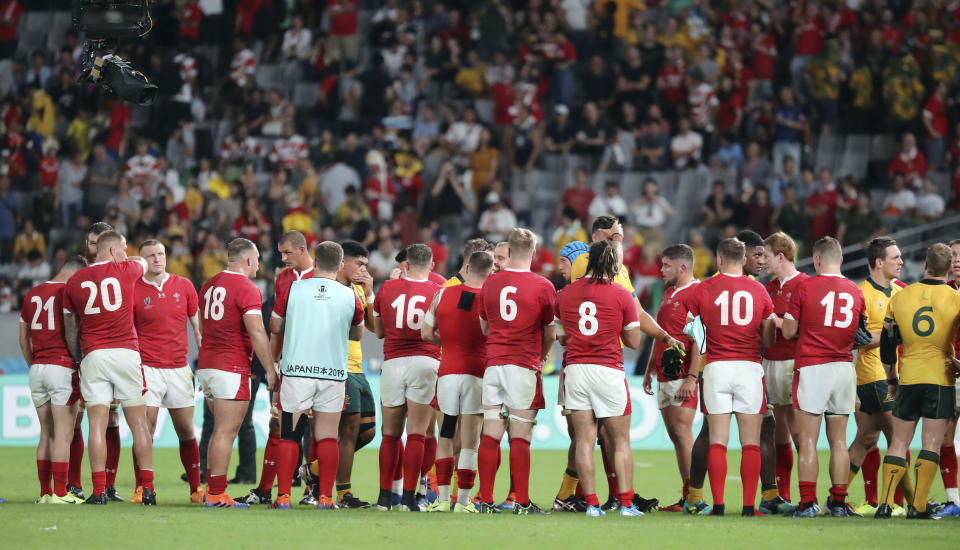 Wales players form a tunnel for Australian players to leave the field after the Rugby World Cup Pool D game at Tokyo Stadium between Australia and Wales in Tokyo, Japan, Sunday, Sept. 29, 2019. Wales won the match 29-25. (AP Photo/Eugene Hoshiko)