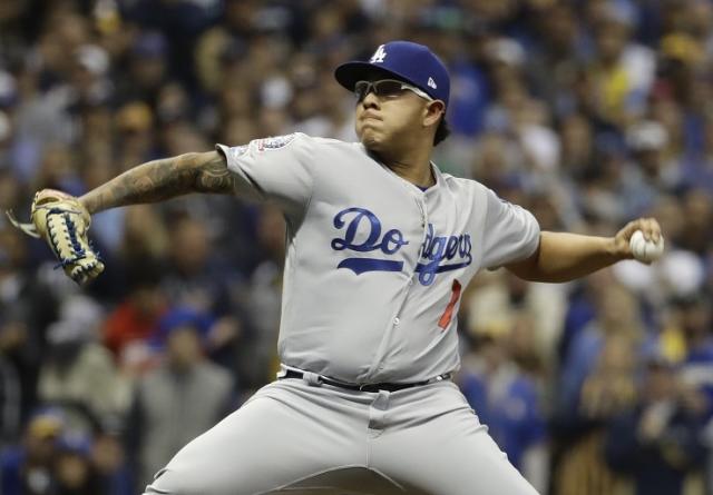 Starting pitcher Julio Urias #7 of the Los Angeles Dodgers warms up in the  bullpen prior to a baseball game between the Los Angeles Dodgers…