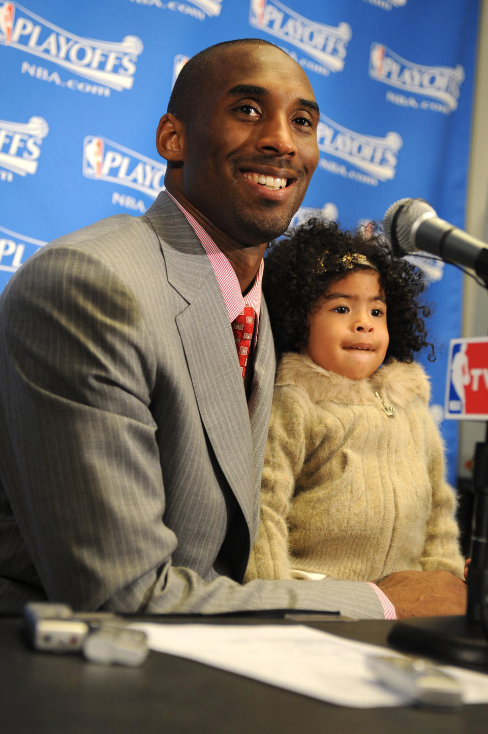 Kobe Bryant #24 of the Los Angeles Lakers answers questions from the media while holding his daughter Gianna, following his team's victory over the Utah Jazz in Game One of the Western Conference Semifinals during the 2008 NBA Playoffs at Staples Center on May 4, 2008 in Los Angeles, California. (Photo by Andrew D. Bernstein/NBAE via Getty Images)