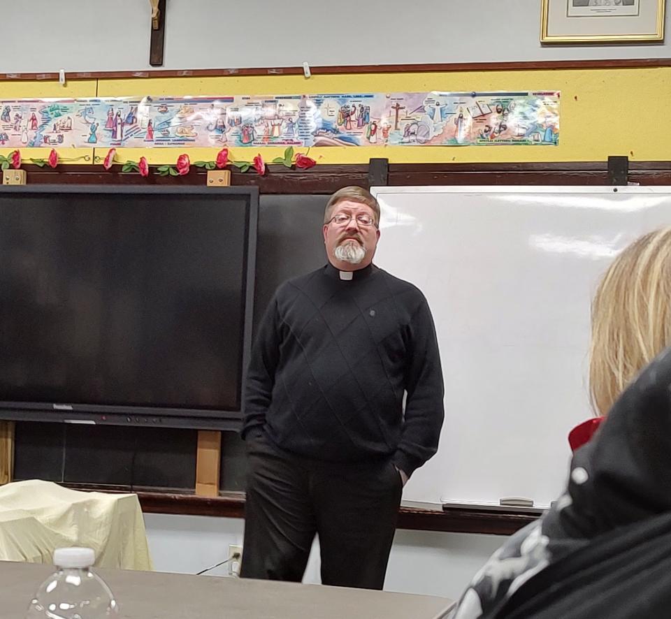 Immaculate Conception Church Rev. James Hartwell addresses a meeting Wednesday night exploring potential uses for the former Immaculate Conception School building on Maple Avenue in Wellsville.
